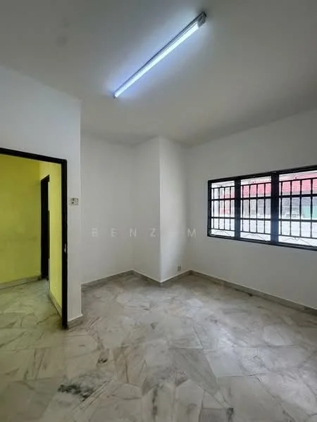 Room features: white painted walls, marble flooring, single fluorescent light fixture, black metal window grills, two windows, corner entry door, neutral color scheme; style: minimalist.