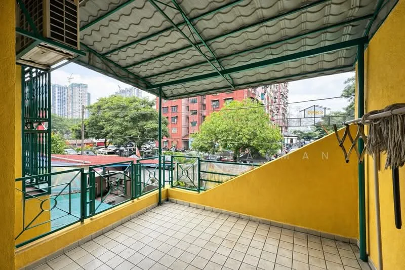 Room features: yellow painted walls, tiled flooring, metal railing, roof overhang, exposed beams, ceiling with corrugated metal, view of surrounding buildings, view of trees, outdoor space; view: city.