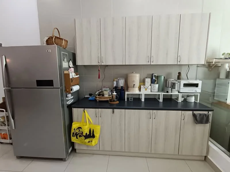 Kitchen features: stainless-steel fridge, light wood cabinetry, black countertop, microwave, kettle, toaster, dish rack, paper towel holder, decorative basket, yellow shopping bag, wall-mounted shelf; style: modern.