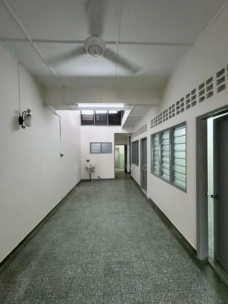 Room features: white painted walls, green terrazzo flooring, ceiling fan, wall-mounted light fixture, sliding windows, doorway leading to another room, open corridor layout, natural light from skylight; style: minimalist.