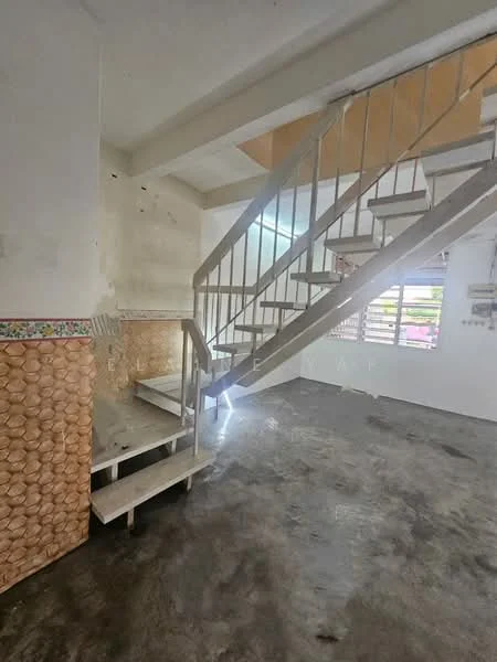 Room features: spiral staircase, concrete flooring, white walls, decorative wall paneling with floral pattern, natural light from windows, stair landing area, exposed ceiling, wall with peeling paint.