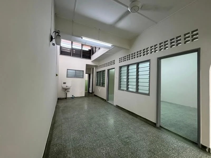 Room features: grey speckled flooring, white painted walls, ceiling fan, multiple windows with metal grilles, doorway leading to another room, utility sink, light fixture on ceiling, ventilation openings near ceiling; style: minimalist.