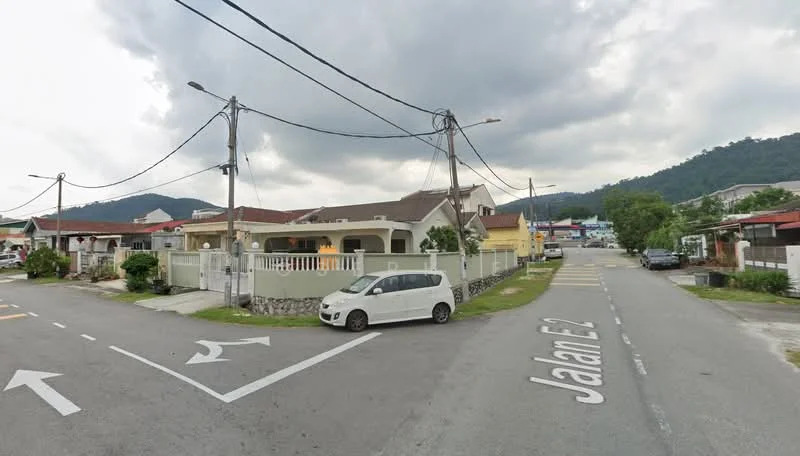 Exterior type: semi-detached house; features: single-storey, white painted facade, front porch with railing, manicured lawn, driveway with interlocking pavers, surrounded by greenery, street view with road signage, power lines visible; style: modern.