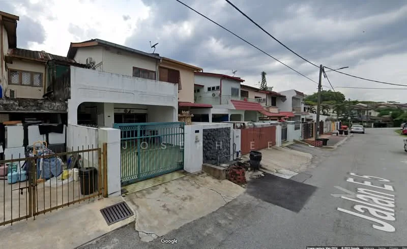 Exterior type: linked terrace house; features: two-storey linked terrace houses, white painted facade, red tiled roof, metal gate, front yard with concrete pavement, visible parking area, street view with road signage, surrounded by greenery; style: modern.