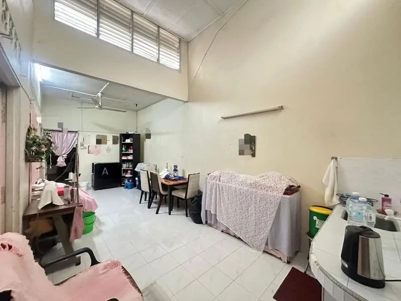 Room features: white painted walls, high ceiling, ceramic tile flooring, ceiling fan, dining table with chairs, sofa, shelves, kitchen countertop, kettle, sink, refrigerator, decorative plants, laundry basket.