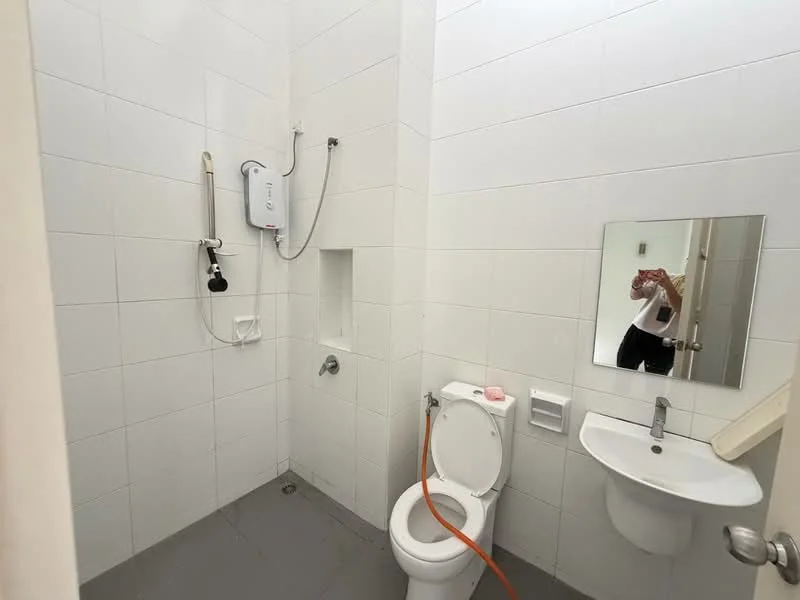 Bathroom features: white tiled walls, grey tiled flooring, one-piece toilet, wall-mounted sink, framed mirror, shower with wall-mounted faucet, water heater, shower hose, soap dish, toilet paper holder; style: modern.
