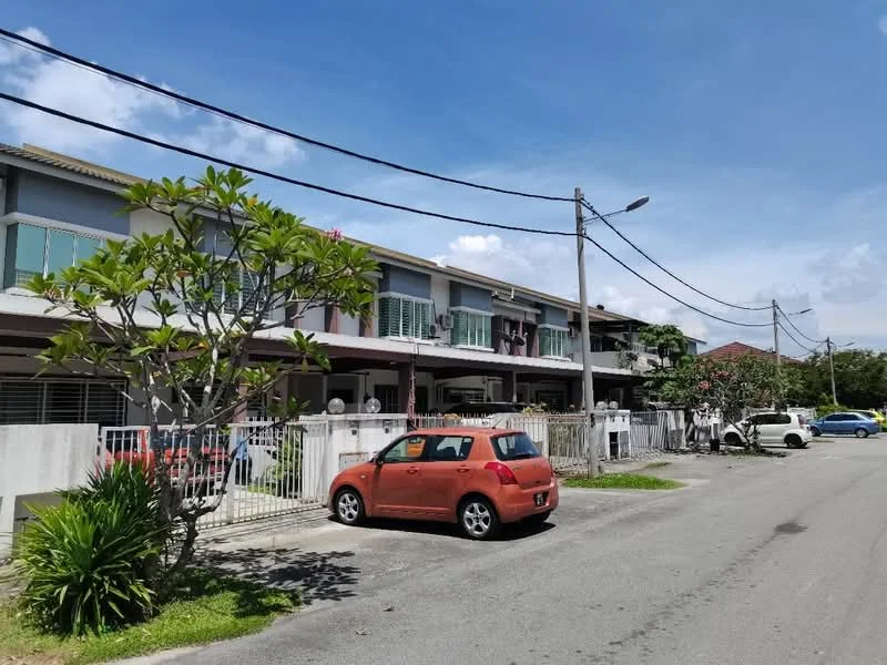 Exterior type: linked terrace house; features: two-storey linked terrace houses, white painted facade, green window shutters, manicured lawn, tropical landscaping with flowering plants, paved driveway, street view with parked cars, overhead power lines, clear blue sky; style: modern.