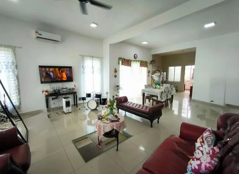 Living features: cream painted walls, white ceiling, recessed downlights, 5-blade ceiling fan, large windows with sheer curtains, tile flooring, 2-seater leather sofa in burgundy, 3-seater leather sofa in burgundy, coffee table with decorative cloth, TV console with wall-mounted TV, decorative pillows, area rug with floral pattern, drum set, dining table in background, kitchen visible in background; style: modern.