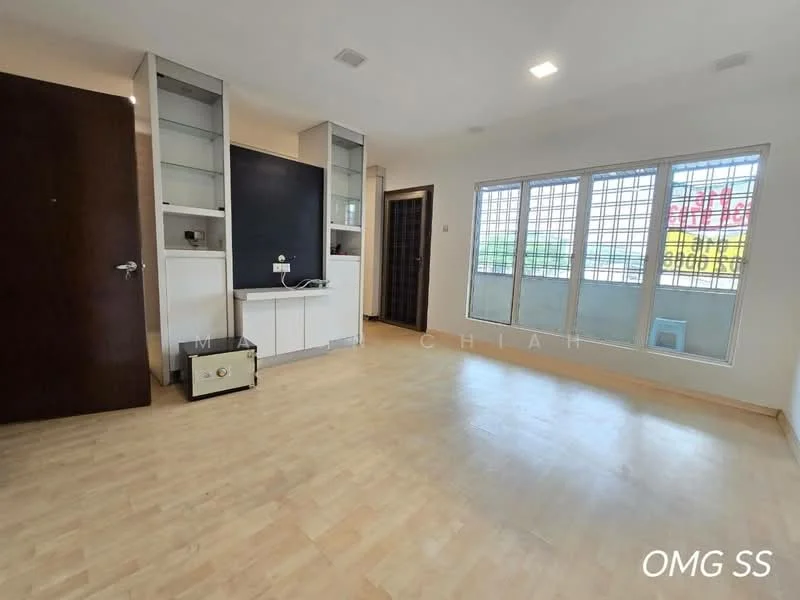 Room features: light wood laminate flooring, white painted walls, built-in shelving unit, black chalkboard wall, large windows with grid pattern, door leading to another room, ceiling lights, corner space for appliances or furniture; style: modern.