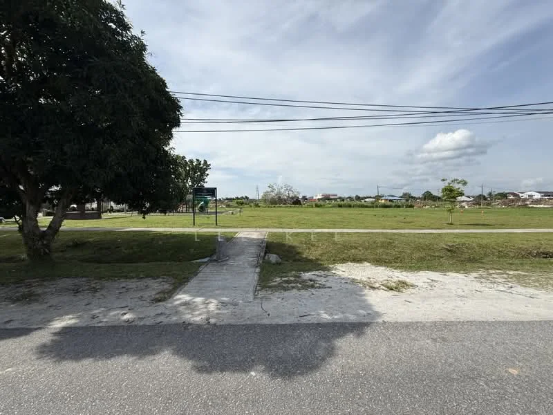 Exterior features: manicured lawn, mature trees, concrete pathway, street view, power lines, open green space.