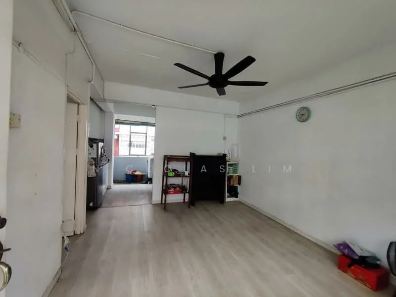 Living features: white painted walls, laminate flooring, 5-blade ceiling fan, wall clock, open layout, large windows, doorway to kitchen, doorway to hallway; style: minimalist.