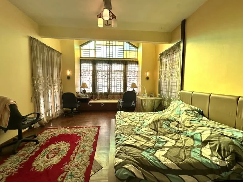 Bedroom features: king-size bed with patterned bedding, upholstered headboard, two bedside lamps, wood flooring, large windows with sheer curtains, decorative area rug with intricate pattern, study desk, office chair, built-in window seat, wall-mounted light fixture; style: traditional.