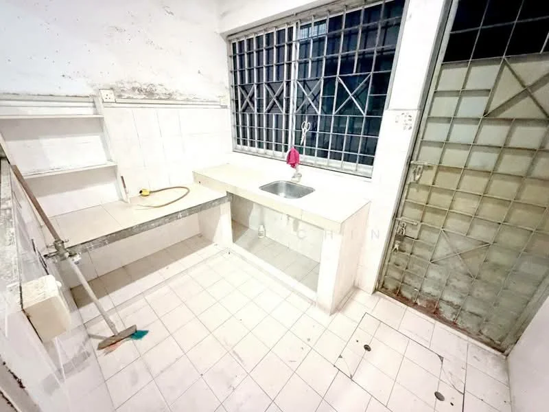 Kitchen features: white tiled walls, white tiled flooring, single-bowl stainless-steel sink, chrome faucet, countertop with storage underneath, open shelving, window with security bars, metal door, water hose, floor drain.
