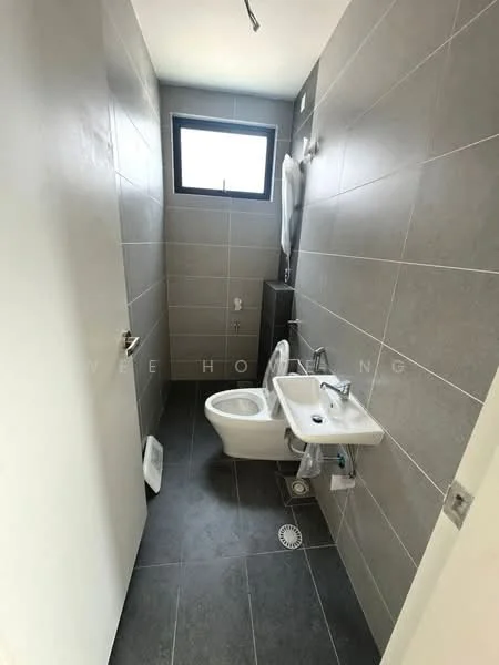 Bathroom features: grey tiled walls, dark grey tile flooring, white toilet, white sink, chrome faucet, small window, wall-mounted mirror, towel rack; style: modern.