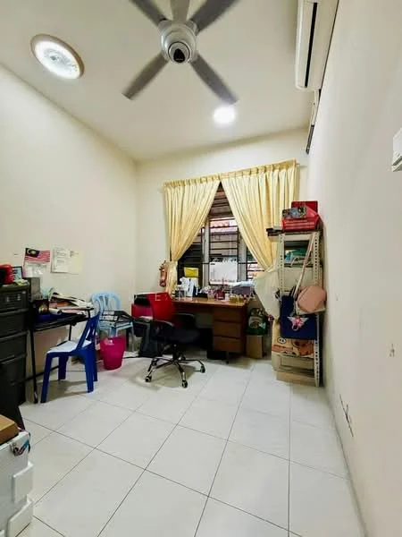 Study features: white painted walls, tile flooring, ceiling fan, window with sheer curtains, wooden desk, black office chair, blue plastic chair, storage shelves, various storage boxes, air conditioning unit.