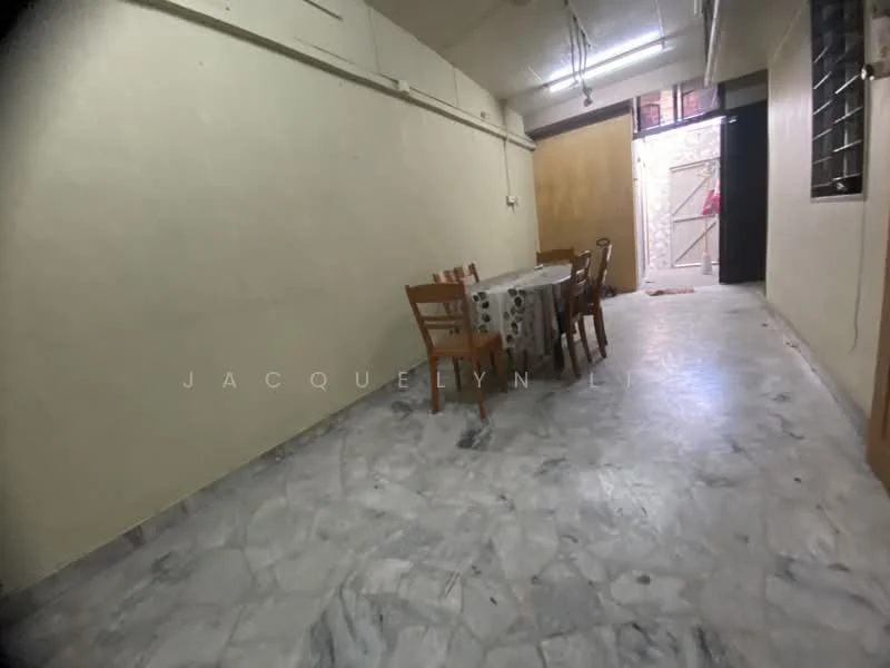 Room features: marble flooring, cream painted walls, dining table with chairs, door leading to another room, window with metal grille, light fixture on ceiling.