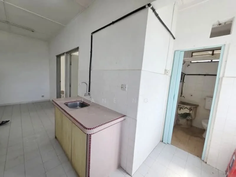 Kitchen features: single-bowl stainless-steel sink, chrome faucet, laminate countertop with pink edge, white tiled walls, white tiled flooring, exposed plumbing, open layout, natural light from window. Bathroom features: toilet, sink with vanity, white tiled walls, white tiled flooring, natural light from window.