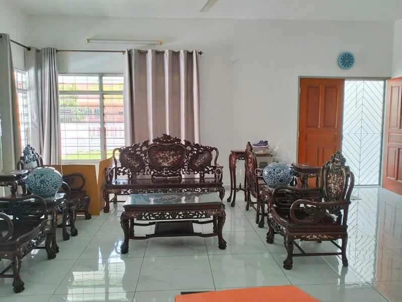 Living features: white painted walls, glossy ceramic tile flooring, large windows with sheer curtains, wooden front door, intricately carved wooden furniture, coffee table, decorative ceramic vases, orange area rug; style: traditional.