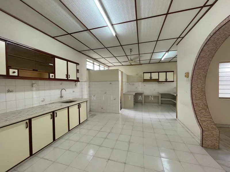 Kitchen features: white tiled walls, cream cabinetry with brown handles, grey countertop, single-bowl stainless-steel sink, chrome faucet, built-in stove with hood, wall-mounted cabinets, floor tiles in white, ceiling with fluorescent lighting, open layout to adjacent area; style: traditional.