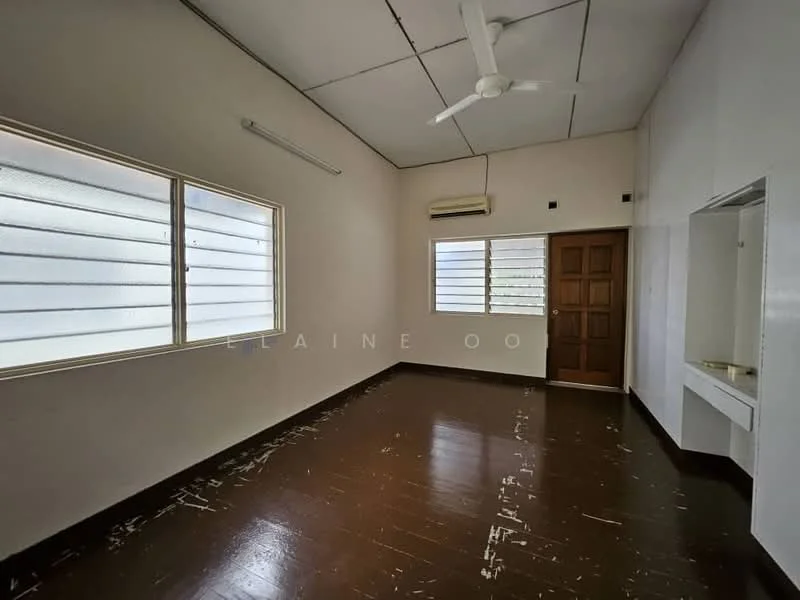 Room features: white painted walls, brown wooden flooring, sliding windows with horizontal bars, 1 wall-mounted split AC, 1 ceiling fan, wooden door, built-in shelf or counter, high ceiling.