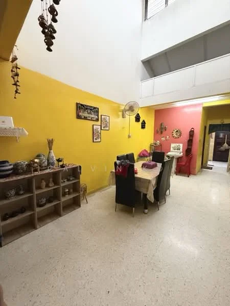 Dining features: yellow painted walls, pink accent wall, dining table with tablecloth, black dining chairs, open shelving unit with decorative items, ceiling fan, decorative wall hangings, flooring with speckled finish, natural light from windows, artwork on walls; style: modern.