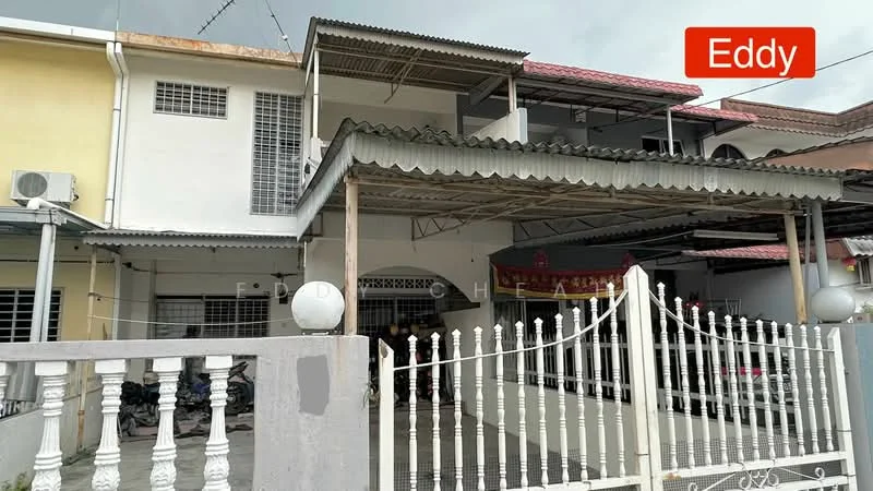 Exterior type: linked terrace house; features: white painted facade, metal roofing, covered car porch, gate with white picket fence, ground floor windows with security bars, decorative awning over porch, visible air conditioning unit, front yard with concrete pathway; style: modern.