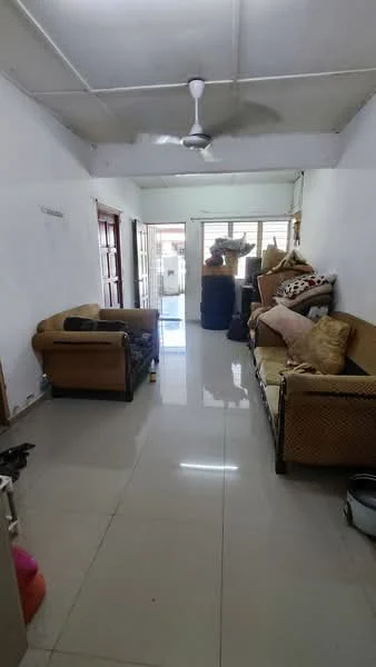 Living features: white painted walls, polished tile flooring, ceiling fan, 2-seater fabric sofa in beige, 3-seater rattan sofa, decorative cushions, natural light from windows, open layout, door leading outside.
