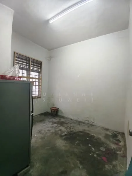 Room features: white painted walls, concrete flooring, single window with metal grille, fluorescent ceiling light, empty space.