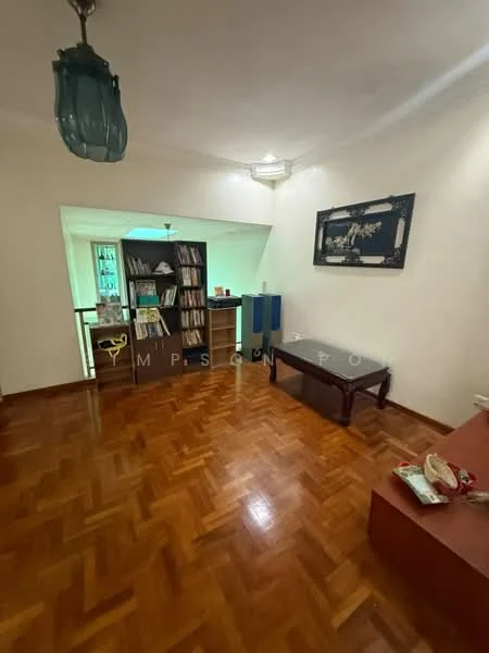 Living features: parquet wood flooring, white painted walls, recessed ceiling lights, wall-mounted artwork, bookshelf with books, coffee table, sofa, decorative items on table; style: modern.
