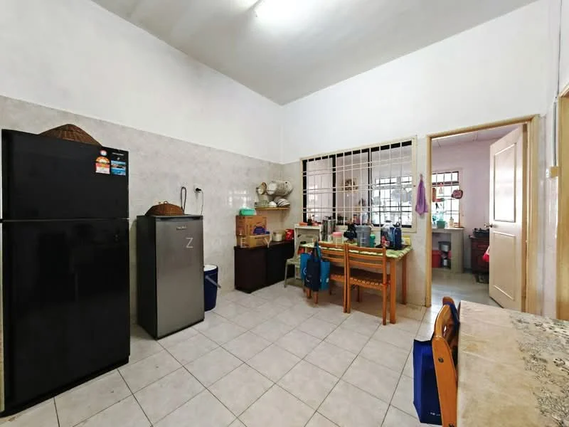 Kitchen features: white painted walls, tile flooring, ceiling light fixture, black refrigerator, silver refrigerator, wooden dining table with chairs, open shelving, kitchen cabinets, sink, window with grid, countertop, decorative basket on countertop.