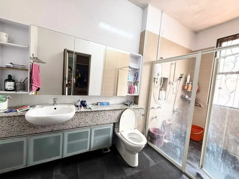 Bathroom features: single-sink vanity with grey countertop, framed mirror above sink, toilet, walk-in shower with glass enclosure, shower head, shower controls, tile cladding on walls, grey floor tiles, built-in shelves, window for natural light, plastic bucket, hanging towels; style: modern.