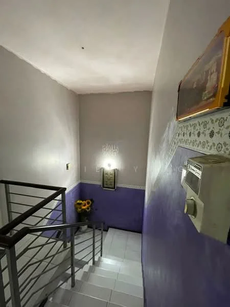 Room features: staircase with metal railing, purple painted walls, white tiled flooring, decorative wall paneling, framed artwork on wall, wall-mounted air conditioning unit, sunflower decoration, ceiling light fixture; style: modern.