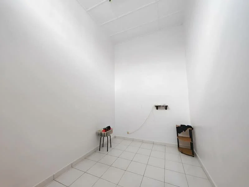 Room features: white painted walls, tile flooring, single light fixture on ceiling, empty space, no visible windows, minimal decor, electrical outlet on wall, small table with chair; style: minimalist.