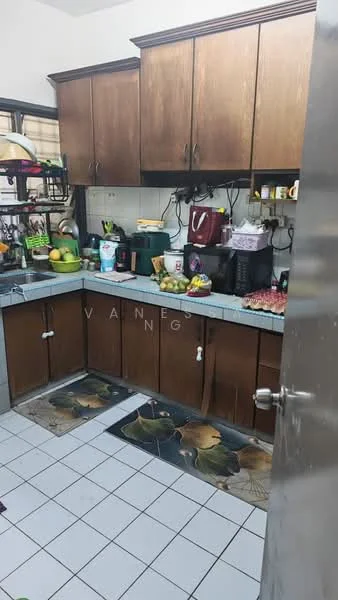 Kitchen features: brown wooden cabinetry, grey laminate countertop, single-bowl stainless-steel sink, chrome pull-down faucet, built-in stove, microwave, toaster, blender, refrigerator, fruit bowl with assorted fruits, kitchen mats with floral pattern, wall-mounted shelves, various kitchen appliances, tile backsplash, white tiled flooring; style: traditional.
