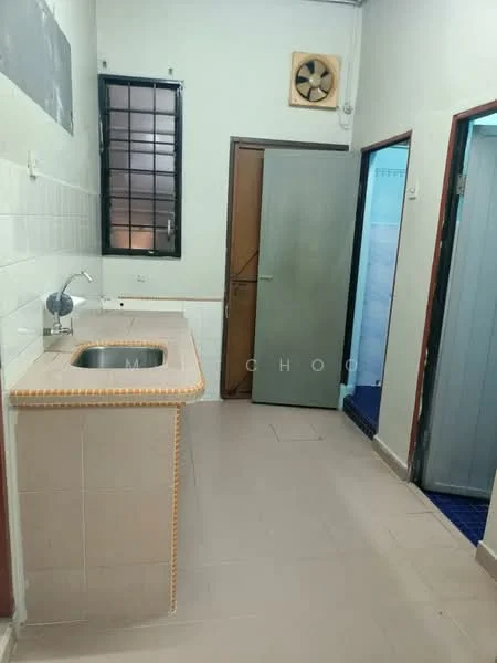 Room features: single-bowl stainless-steel sink, wall-mounted fan, white tiled walls, light beige tiled flooring, wooden door, metal door, window with black frame, countertop with edge detailing.