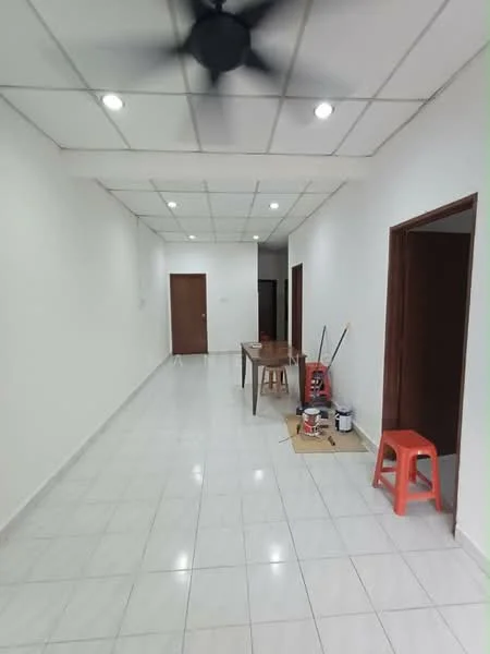 Room features: white painted walls, glossy white floor tiles, ceiling with recessed lighting, 5-blade ceiling fan, wooden doors, table, red plastic stool, paint cans on the floor; style: modern.