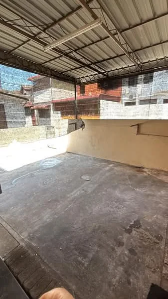 Exterior type: car porch; features: concrete flooring, metal roof, surrounded by walls, open space, partially shaded area, drainage outlet; style: minimalist.