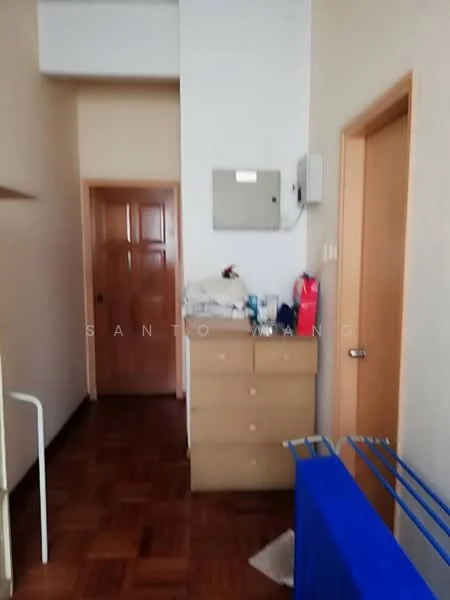 Room features: wooden flooring, cream painted walls, built-in dresser with drawers, wooden door, light switch, wall-mounted electrical panel, clothes drying rack, open space, neutral decor.