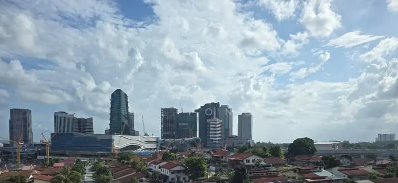 Exterior type: high-rise condominium; features: city skyline, mixed-use development, modern architecture, construction cranes visible, surrounded by residential buildings, clear blue sky with clouds; style: modern.