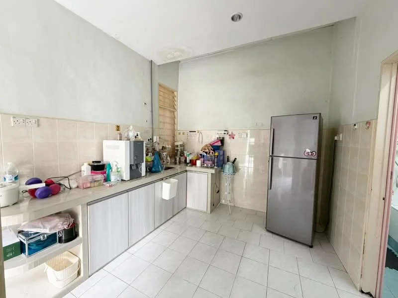 Kitchen features: light green painted walls, white tiled flooring, grey cabinetry, stainless-steel fridge, built-in countertop, sink, various kitchen appliances, open shelving, window, wall-mounted storage.