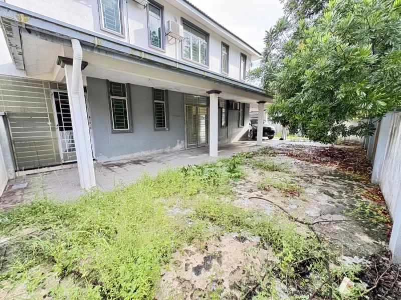 Exterior type: detached bungalow; features: two-storey building, concrete facade, grey painted walls, covered porch area, paved walkway, overgrown garden, mature trees, windows with metal grilles, car parked in driveway; style: modern.