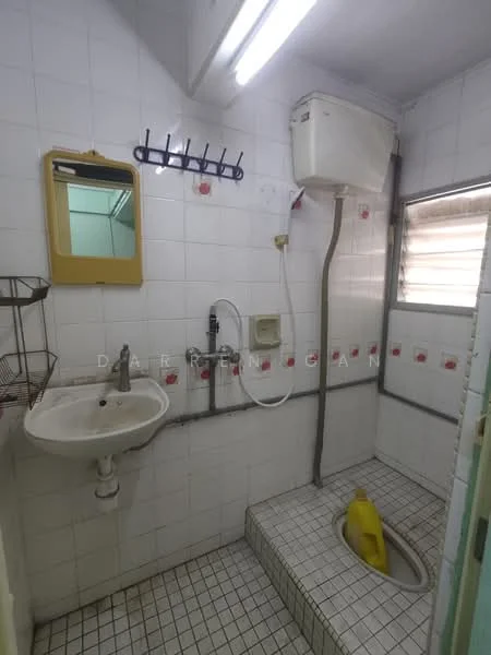 Bathroom features: white tiled walls, white tiled flooring, sink with chrome faucet, mirror above sink, shower head, toilet, wall-mounted water heater, window with blinds, soap dish, towel rack, basket for toiletries.