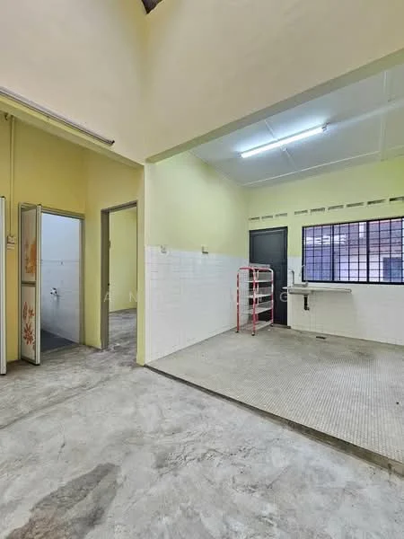 Laundry features: yellow painted walls, grey tiled flooring, white tiled walls, window with metal grilles, sink with faucet, clothes drying rack, fluorescent ceiling lights. Room features: doorway leading to another room, grey concrete flooring.