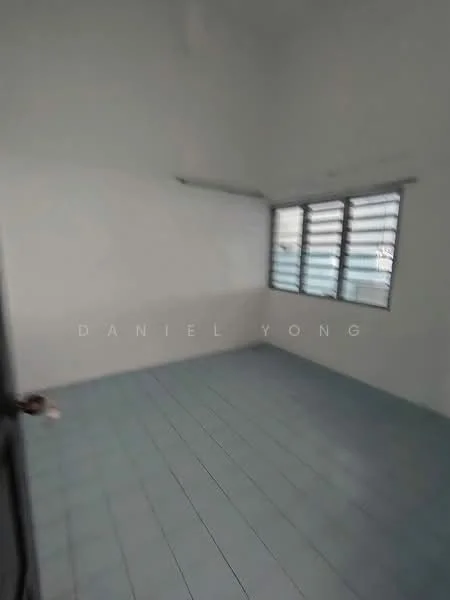 Room features: white painted walls, blue ceramic tile flooring, sliding windows with metal grilles, high ceiling, no visible furniture, single door entry.
