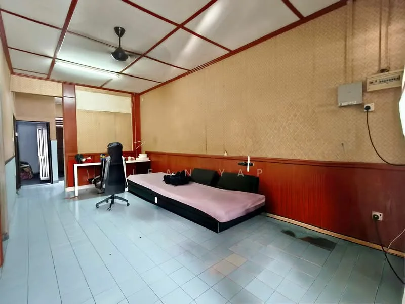 Room features: light blue vinyl flooring, cream painted walls, wood paneling, exposed ceiling beams, ceiling fan, single bed with black frame, desk with chair, power outlet on wall, wall-mounted air conditioning unit.
