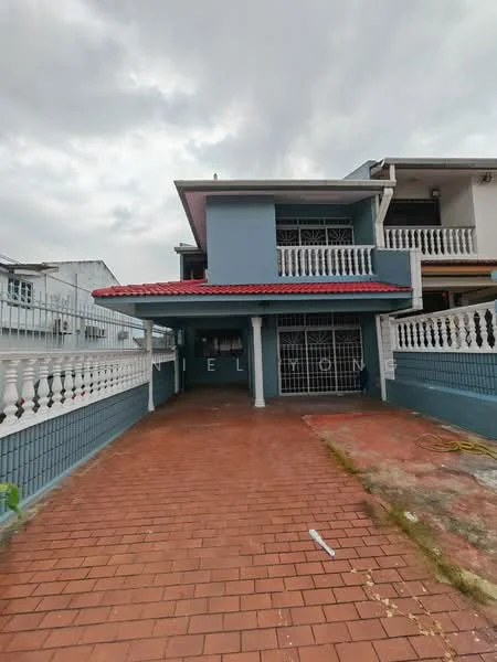 Exterior type: semi-detached house; features: blue painted facade, red tiled roof, brick driveway, white railing, front porch, two-storey structure, windows with security grills, manicured lawn, paved walkway, surrounding residential area; style: modern.
