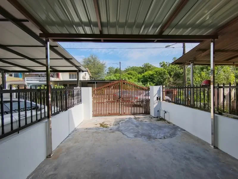 Exterior type: car porch; features: metal roof, concrete flooring, white painted walls, metal railings, wooden gate, surrounded by greenery, open-air design, driveway access; style: modern.