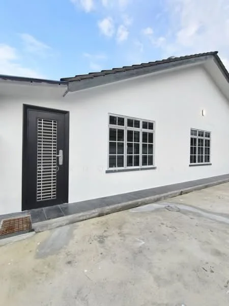 Exterior type: detached bungalow; features: white painted facade, flat roof, single-storey, grey tiled walkway, metal security grille on door, large windows with grid pattern, concrete flooring, outdoor lighting, surrounding open space; style: modern.