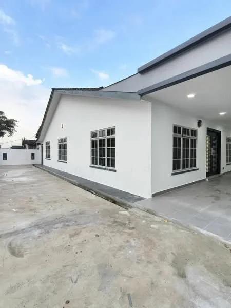 Exterior type: detached bungalow; features: white painted facade, flat roof, approximately single-storey, large windows with black frames, concrete flooring, manicured lawn area, surrounded by open space; style: modern.