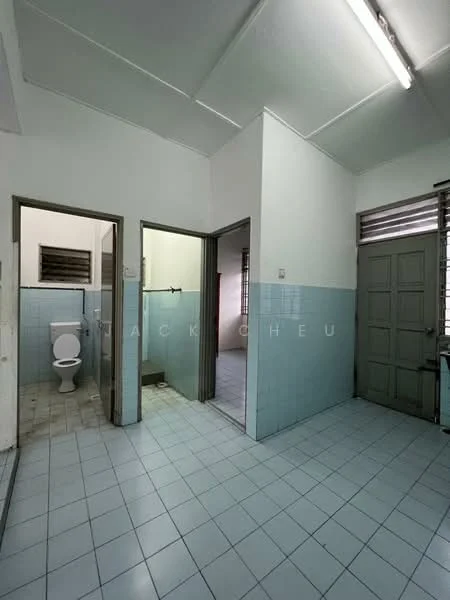 Room features: white painted walls, light blue tiled walls, white tiled flooring, fluorescent ceiling lights, toilet, shower area, open doorway, window with metal grille.